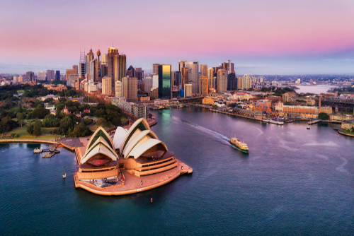 Aerial view of Sydney Opera House and city skyline.