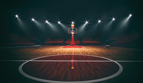 Interior,View,Of,An,Illuminated,Basketball,Stadium,For,A,Game