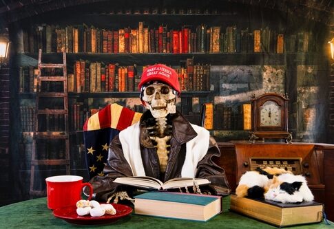 Skeleton,Reading,Book,In,Retro,Library,Wearing,Red,Maga,Hat