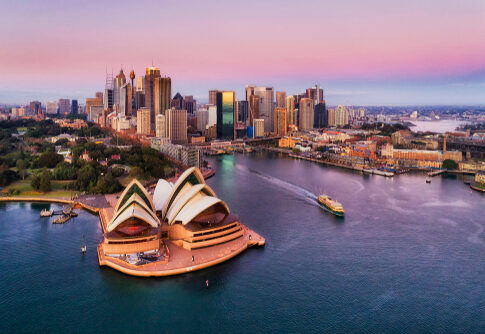Aerial view of Sydney Opera House and city skyline.