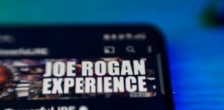 Smartphone screen with Joe Rogan Experience logo visible
