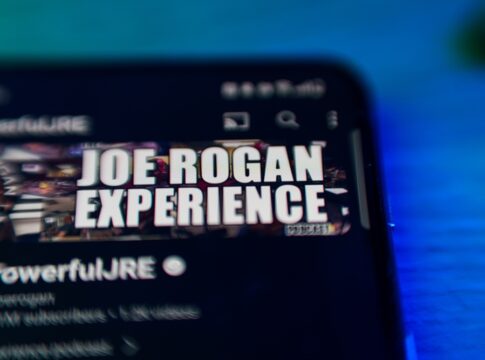 Smartphone screen with Joe Rogan Experience logo visible